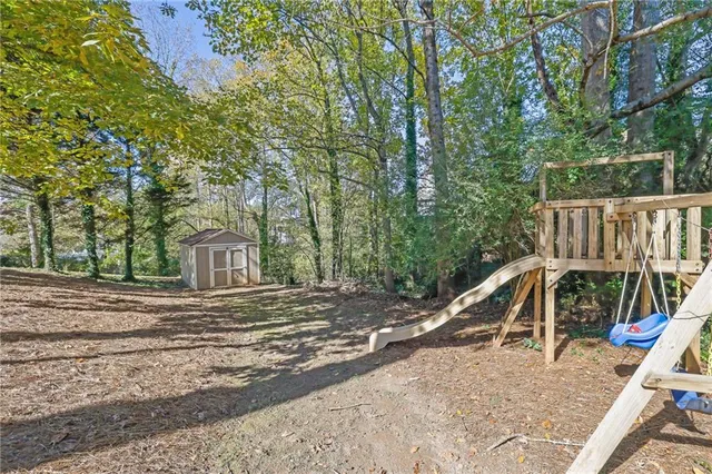 a view of house with backyard and trees