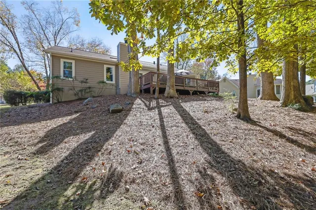 a backyard of a house with table and chairs