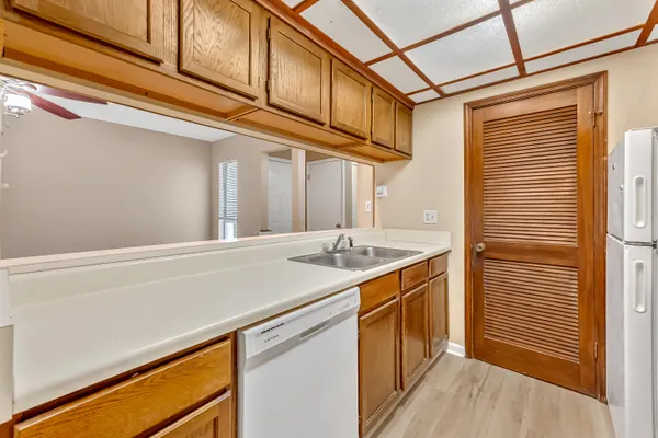 a kitchen with a sink and a refrigerator