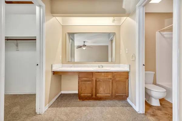 a bathroom with a sink a toilet and a mirror