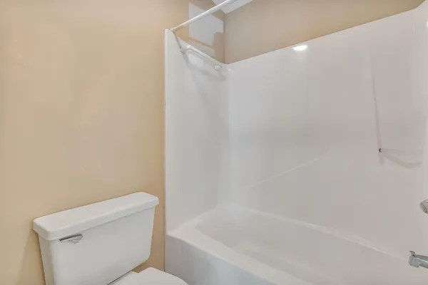 a white bath tub sitting next to a white toilet