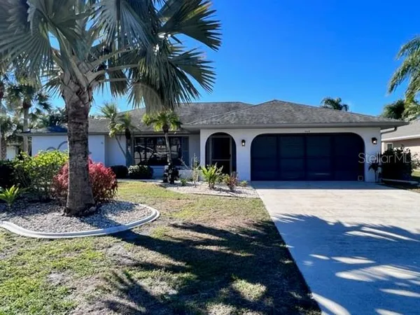 a front view of a house with yard and garage
