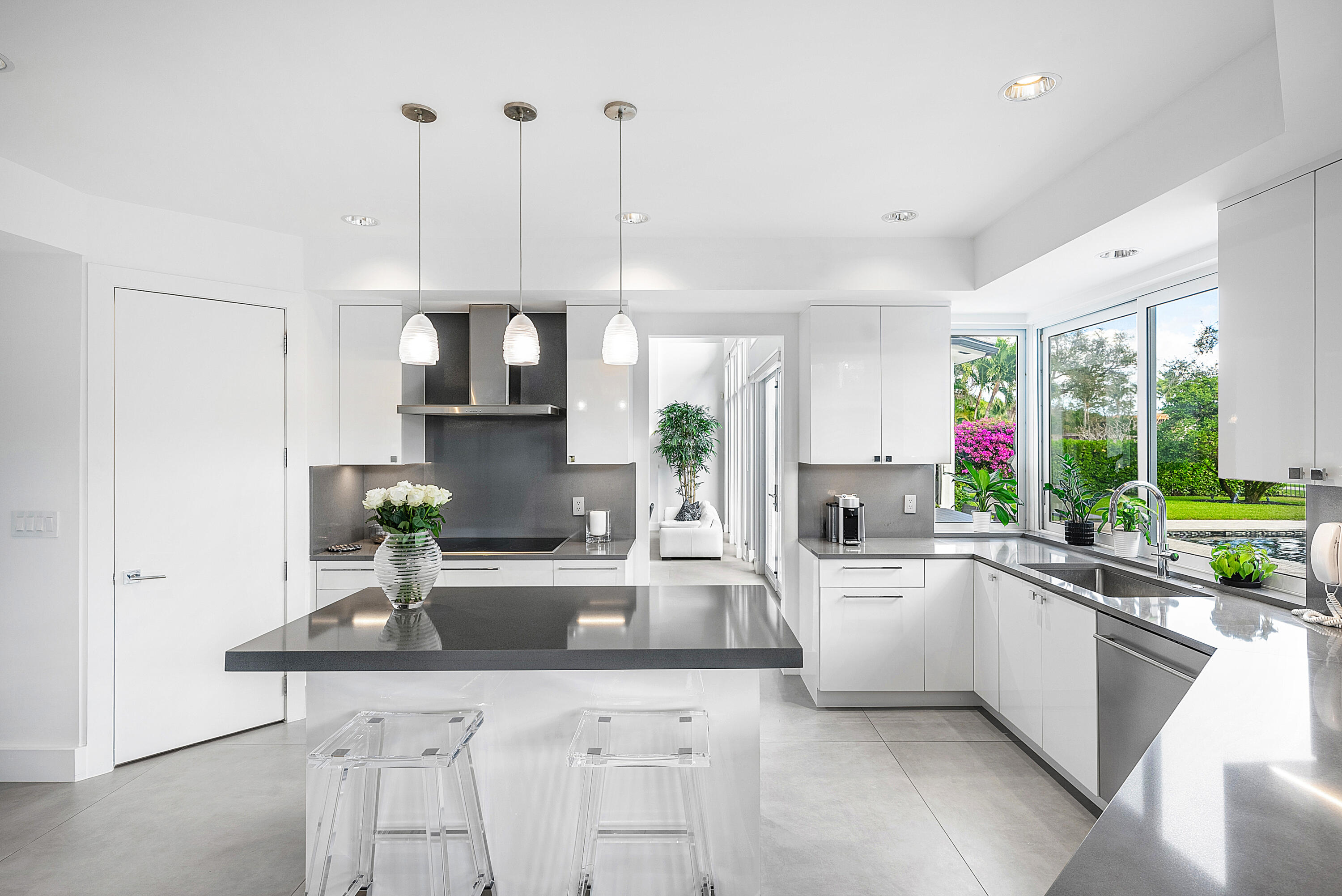 3710 Northwest 53rd Street Boca Raton, FL 33496 - Photo 11 of 42 a kitchen with a sink window and cabinets