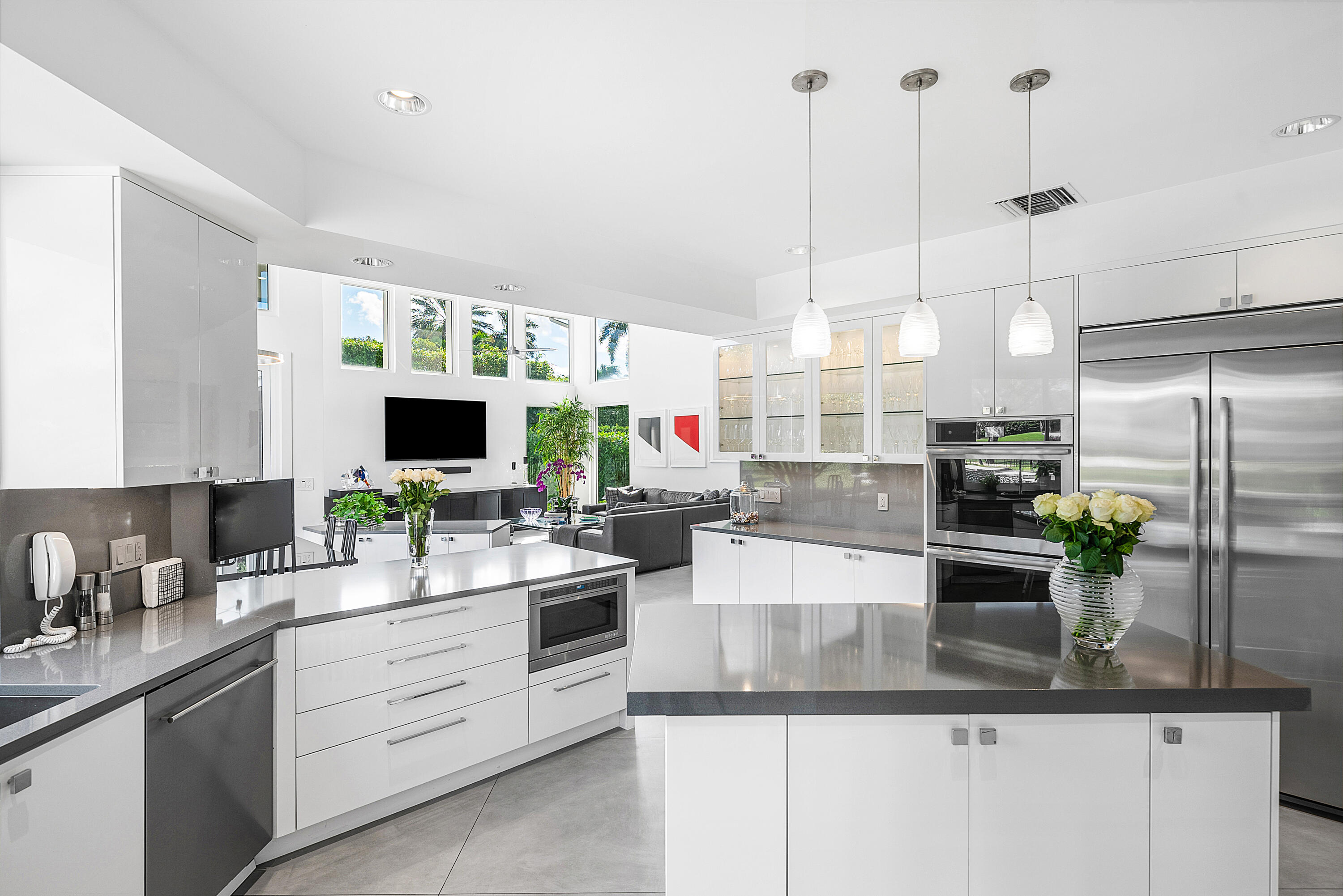 3710 Northwest 53rd Street Boca Raton, FL 33496 - Photo 12 of 42 a kitchen with stainless steel appliances kitchen island granite countertop a sink and white cabinets