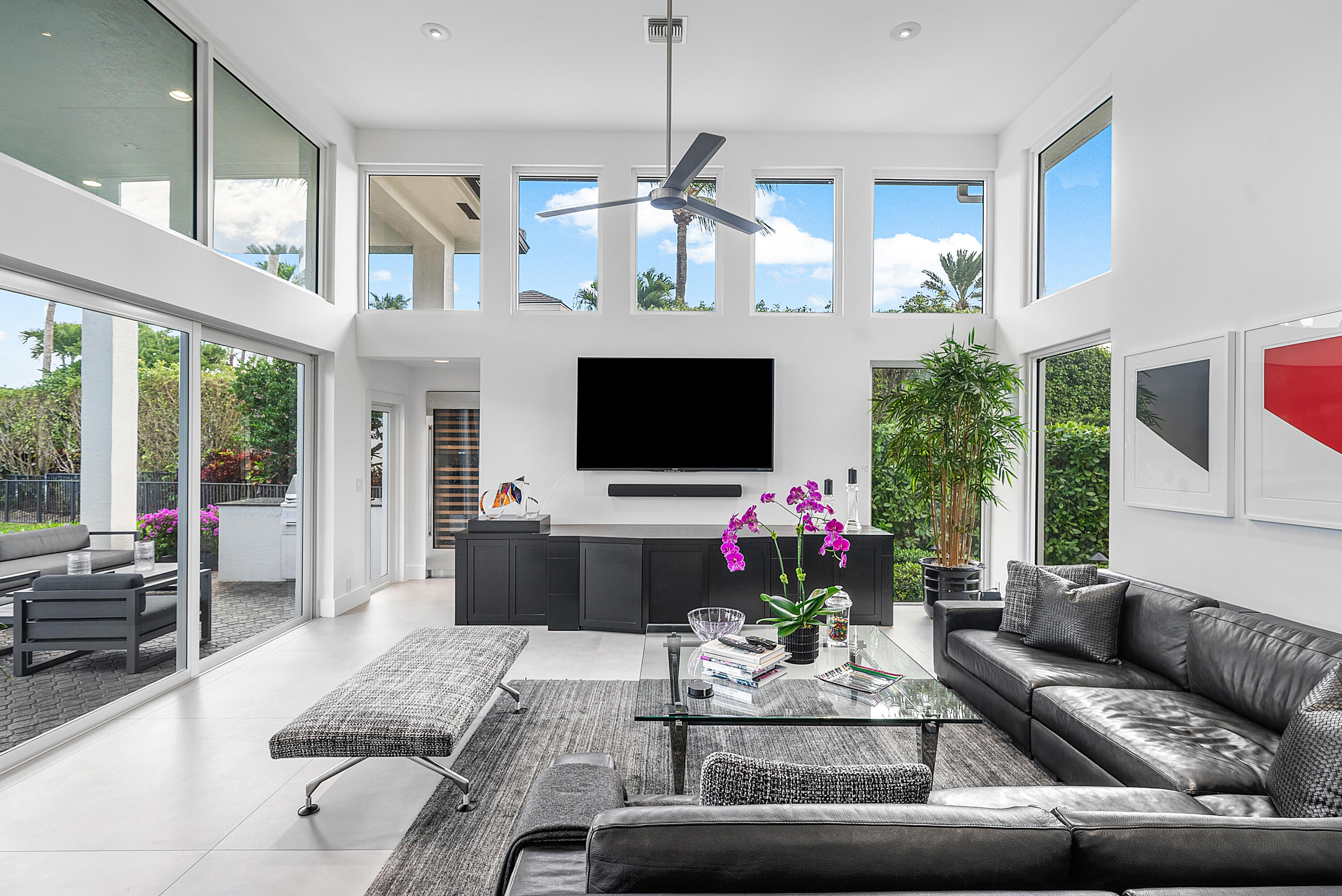 3710 Northwest 53rd Street Boca Raton, FL 33496 - Photo 18 of 42 a living room with furniture a flat screen tv and a chandelier
