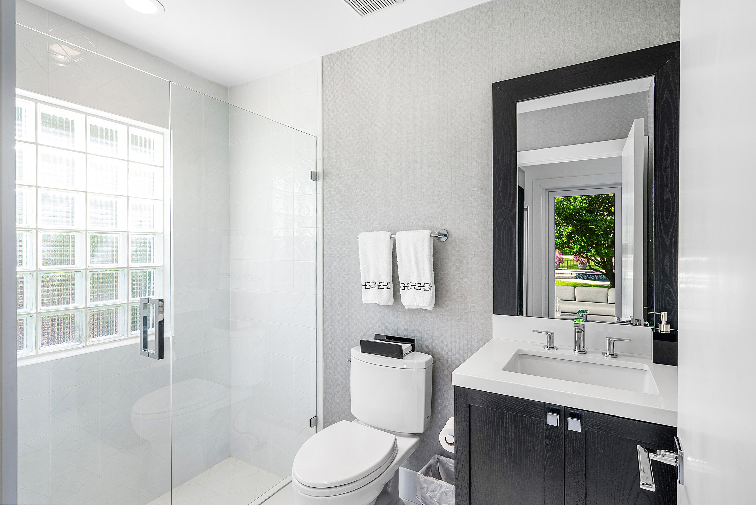 3710 Northwest 53rd Street Boca Raton, FL 33496 - Photo 19 of 42 a bathroom with a toilet a sink a mirror a window and vanity