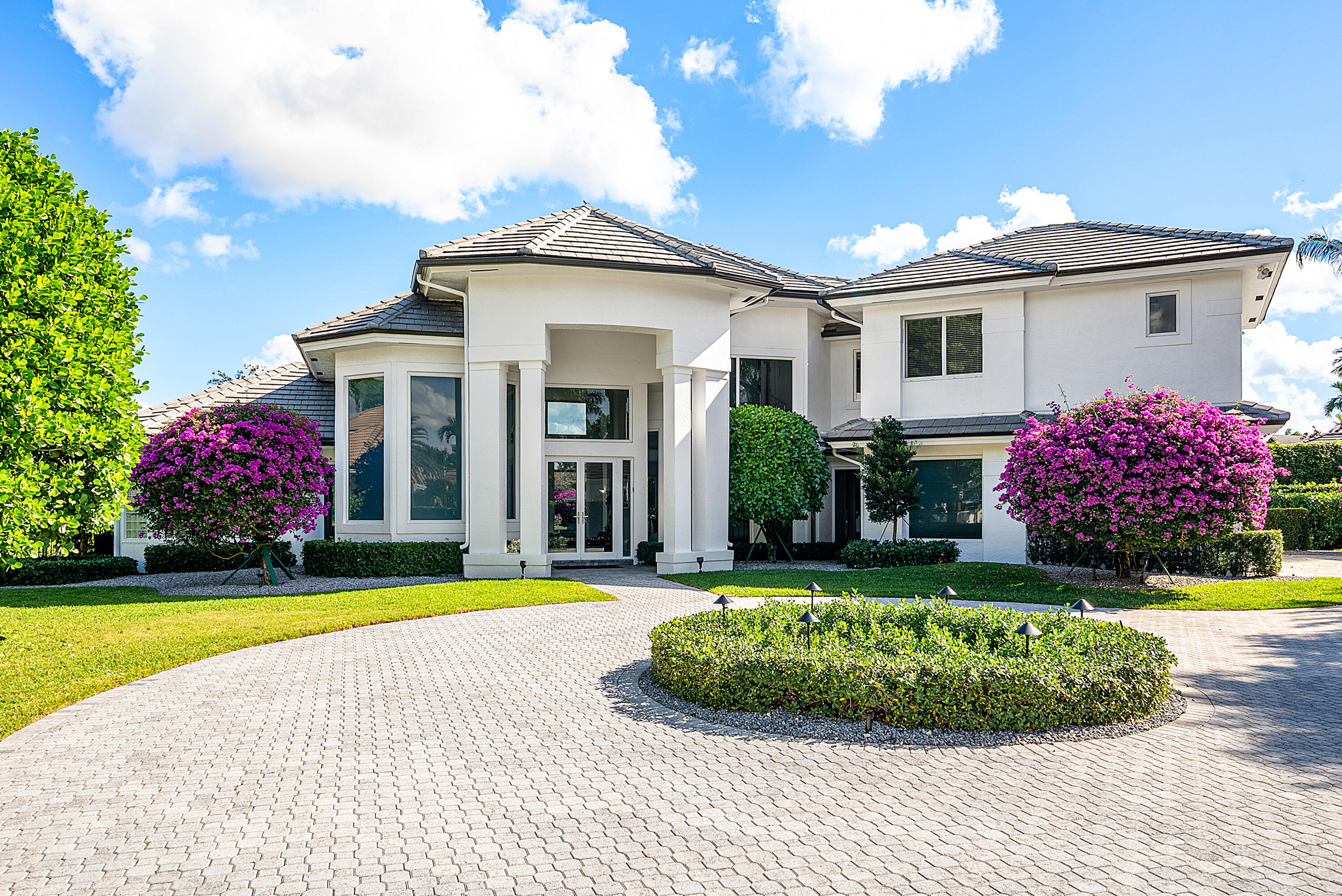 3710 Northwest 53rd Street Boca Raton, FL 33496 - Photo 2 of 42 a view of a white house with a big yard and potted plants
