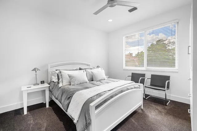 a bed room with a bed and a chair