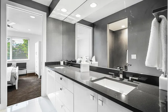 a bathroom with a double vanity sink and a mirror