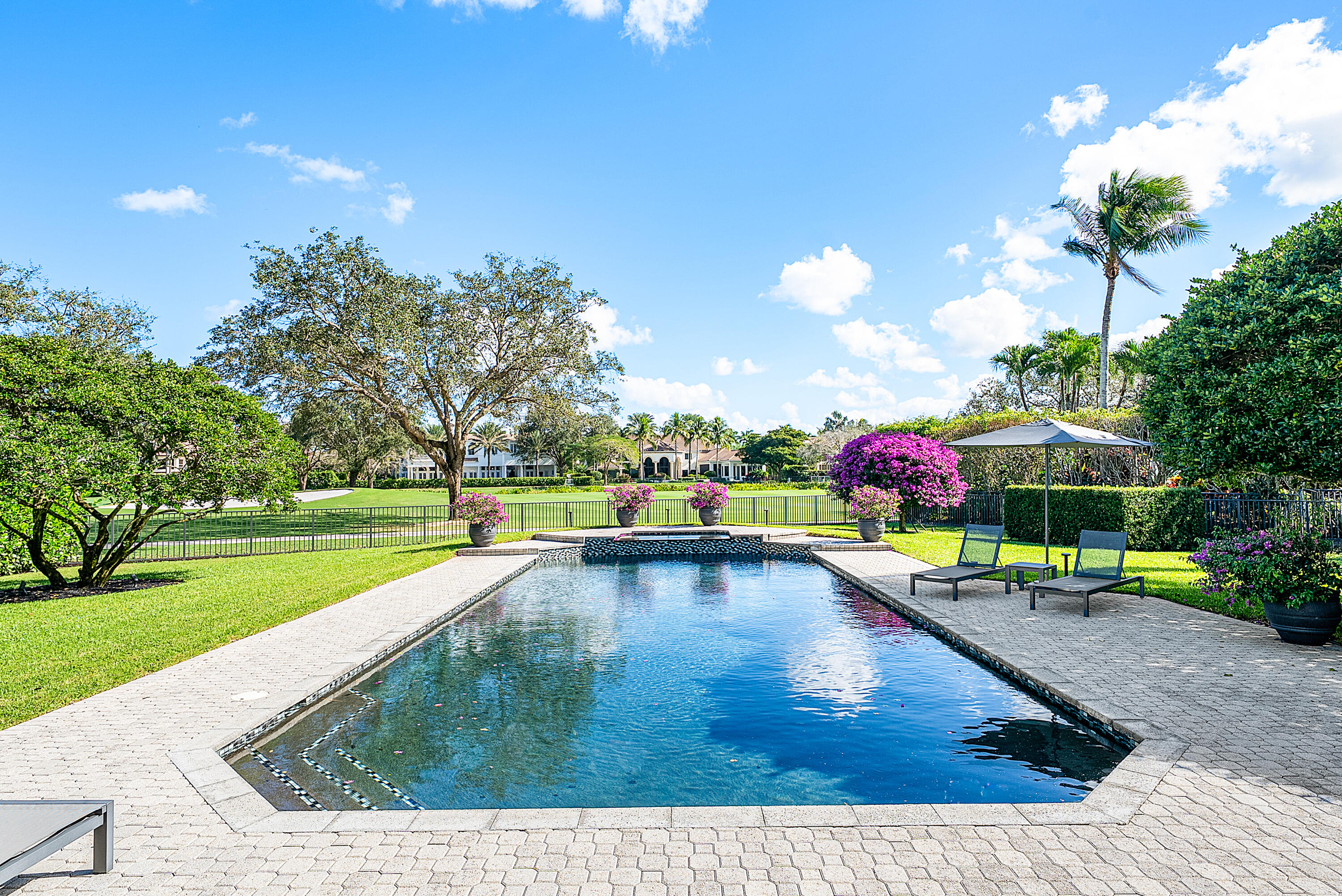 3710 Northwest 53rd Street Boca Raton, FL 33496 - Photo 37 of 42 a view of a swimming pool with a patio and a garden