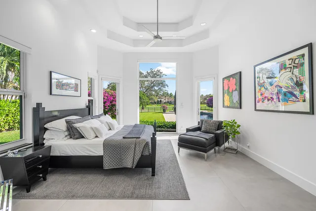 a living room with furniture large window and a flat screen tv