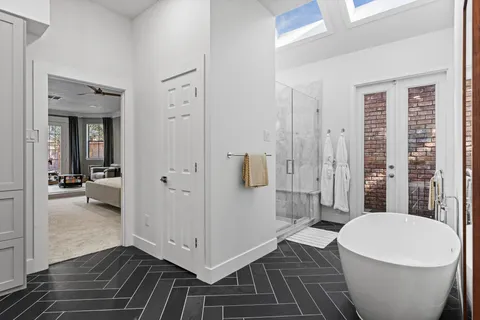 a bathroom with a white tub and shower