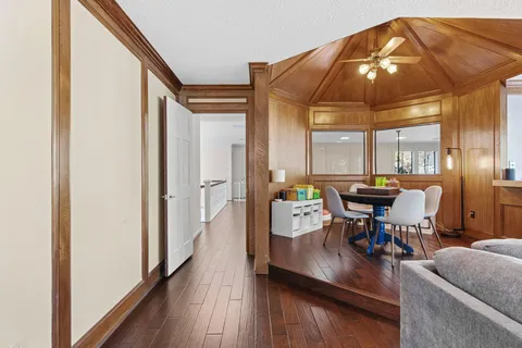 a dining room with furniture and wooden floor