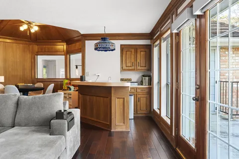 a living room with kitchen island furniture and a chandelier