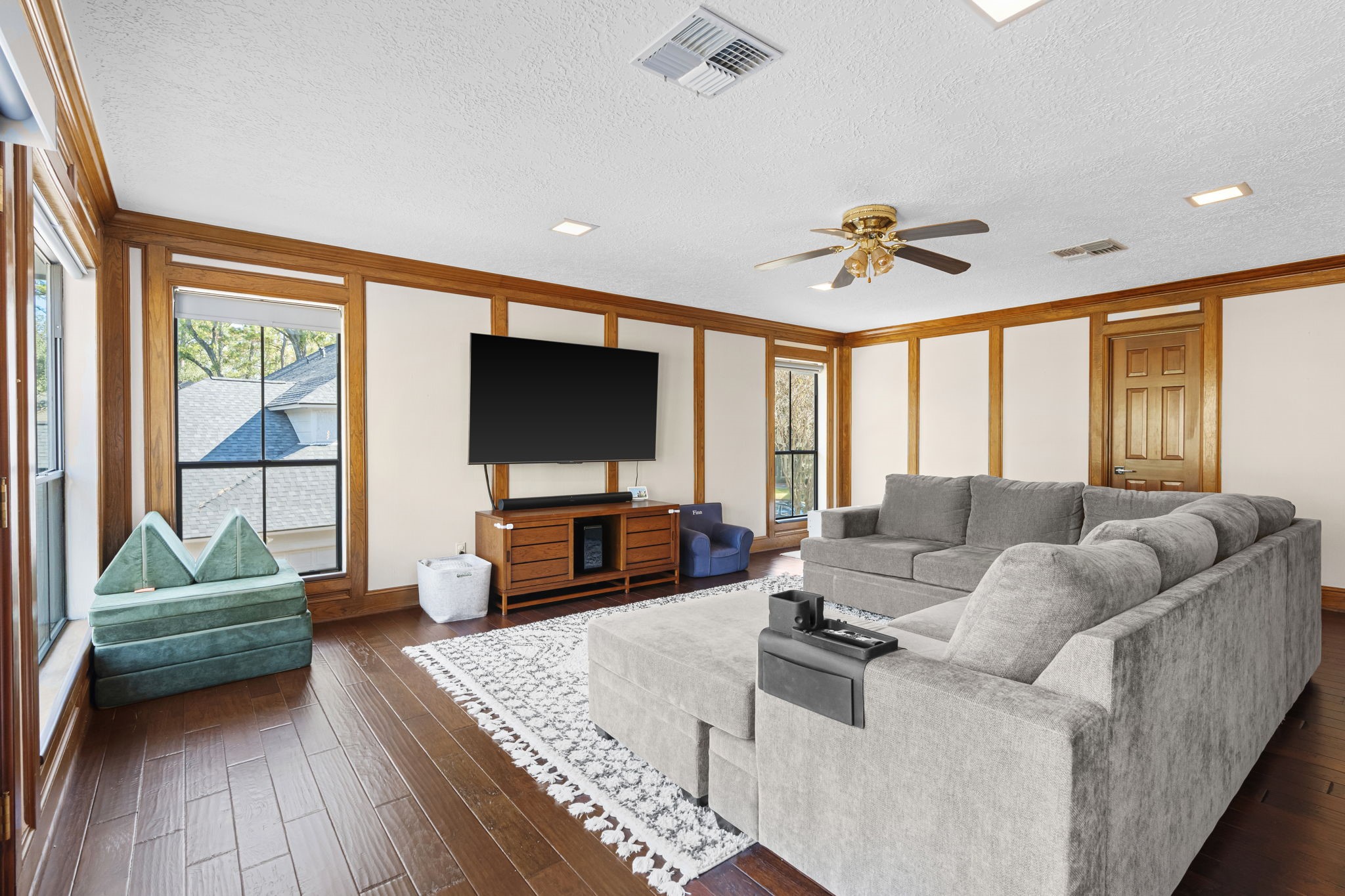 9410 Windrush Drive Spring, TX 77379 - Photo 30 of 50 a living room with furniture and a flat screen tv