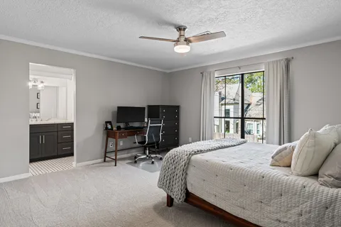 a bedroom with a bed and a television