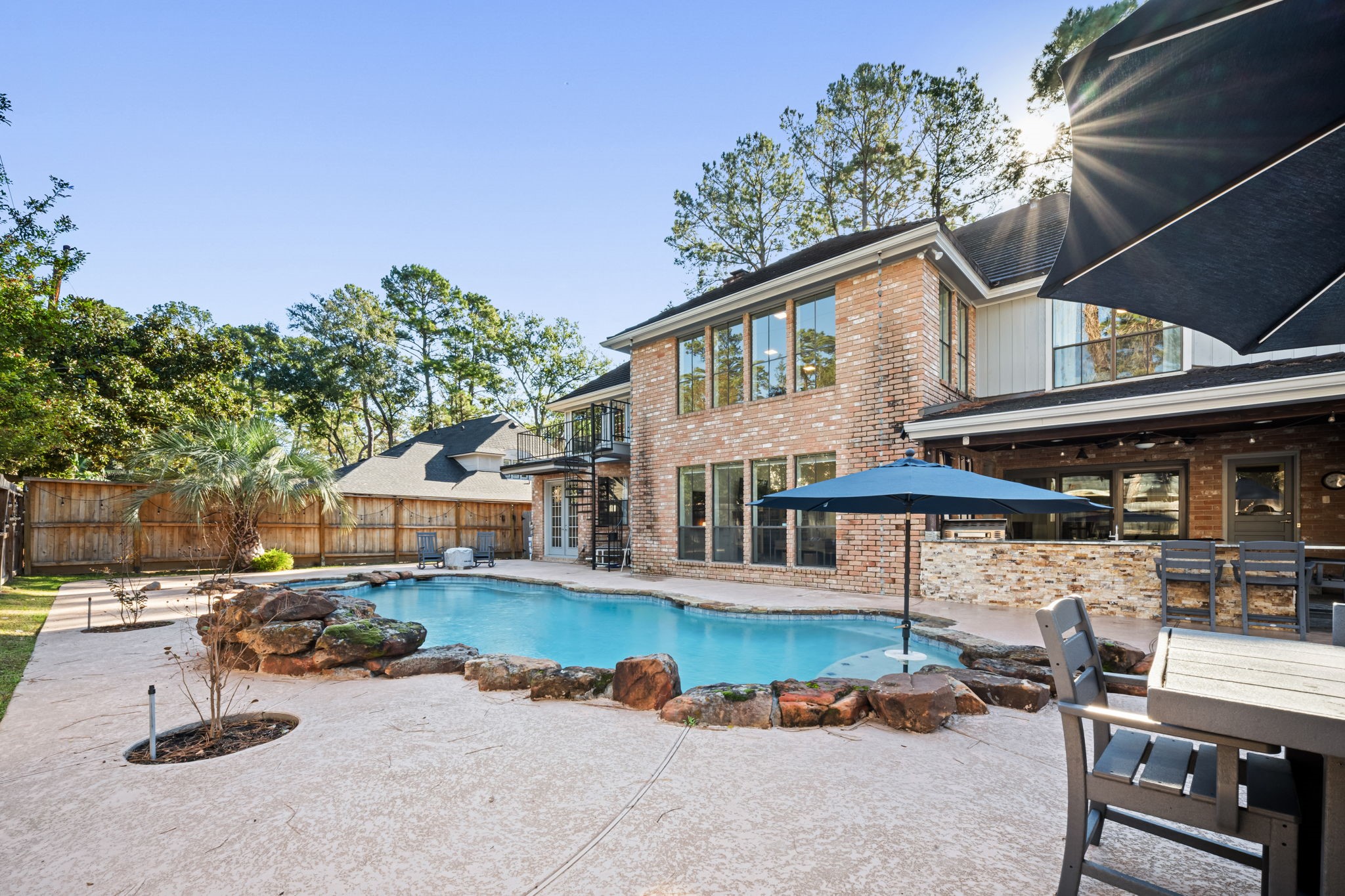 9410 Windrush Drive Spring, TX 77379 - Photo 43 of 50 a view of a patio with table and chairs under an umbrella