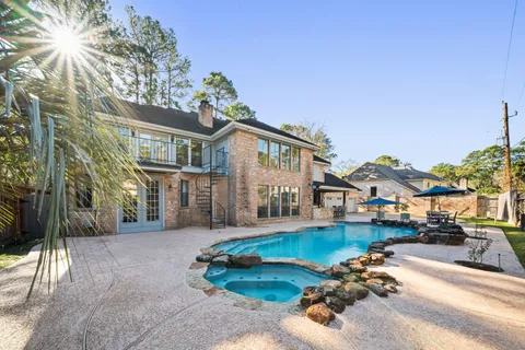 a front view of a house with a garden and yard