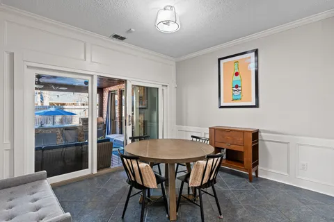 a view of a dining room with furniture and a potted plant
