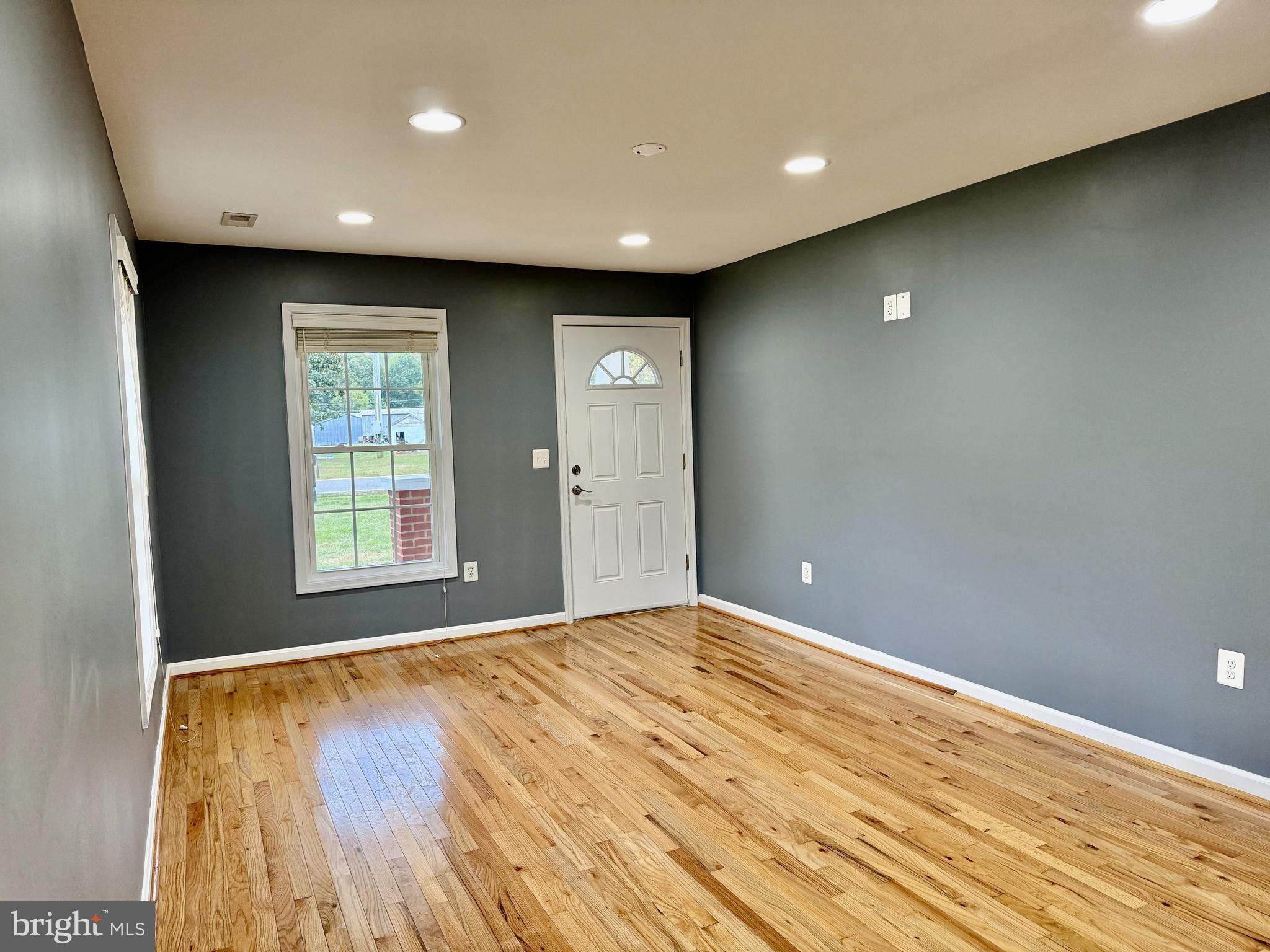 722 Hartwood Road Fredericksburg, VA 22406 - Photo 2 of 28 a view of an empty room with wooden floor and a window
