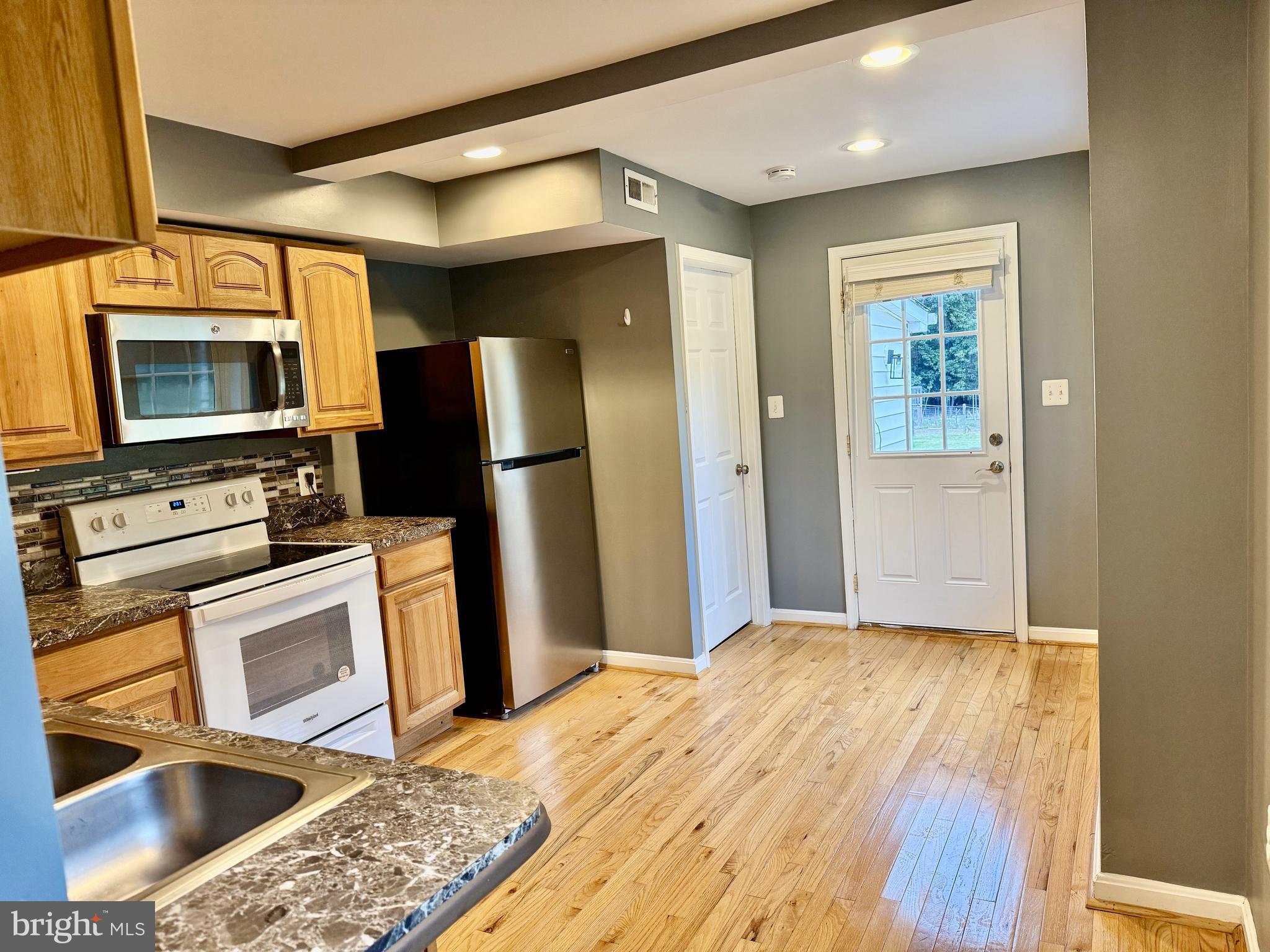 722 Hartwood Road Fredericksburg, VA 22406 - Photo 7 of 28 a kitchen with stainless steel appliances granite countertop a refrigerator stove top oven and sink