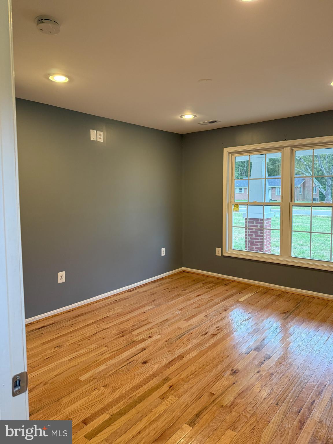 722 Hartwood Road Fredericksburg, VA 22406 - Photo 8 of 28 a view of an empty room with wooden floor and a window