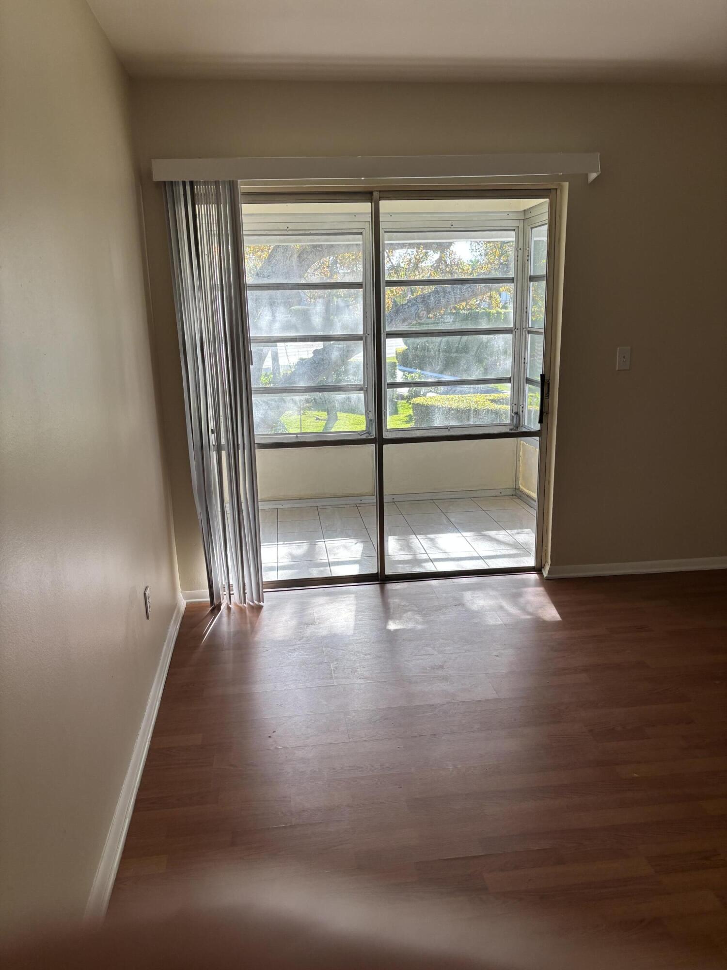 2929 Southeast Ocean Boulevard, Unit G6 Stuart, FL 34996 - Photo 8 of 10 wooden floor in an empty room with a window