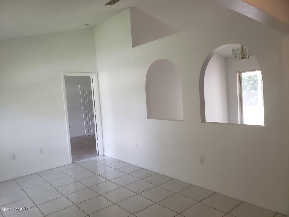 1280 Seabold Road Southwest Palm Bay, FL 32908 - Photo 11 of 28 a view of a livingroom with wooden floor and a window