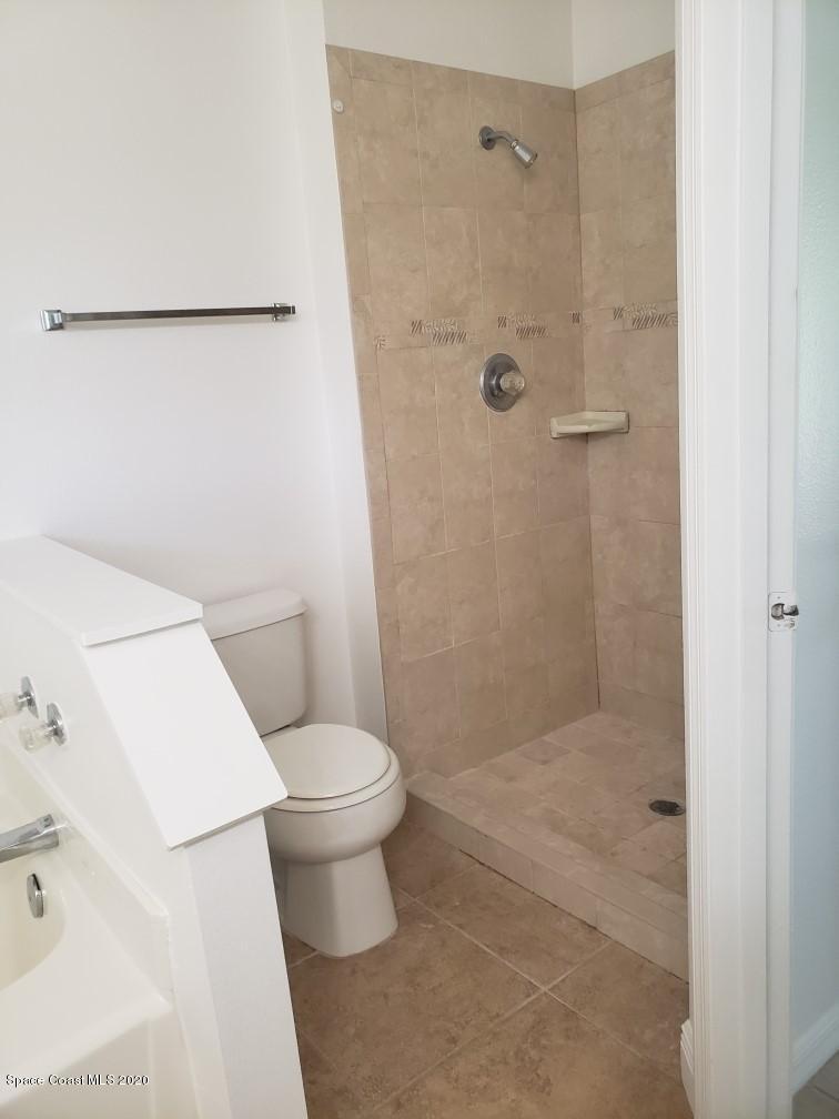 1280 Seabold Road Southwest Palm Bay, FL 32908 - Photo 18 of 28 a white toilet sitting next to a bath tub