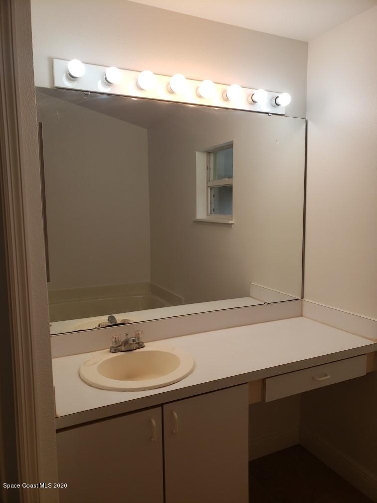 1280 Seabold Road Southwest Palm Bay, FL 32908 - Photo 20 of 28 a bathroom with a sink and a mirror