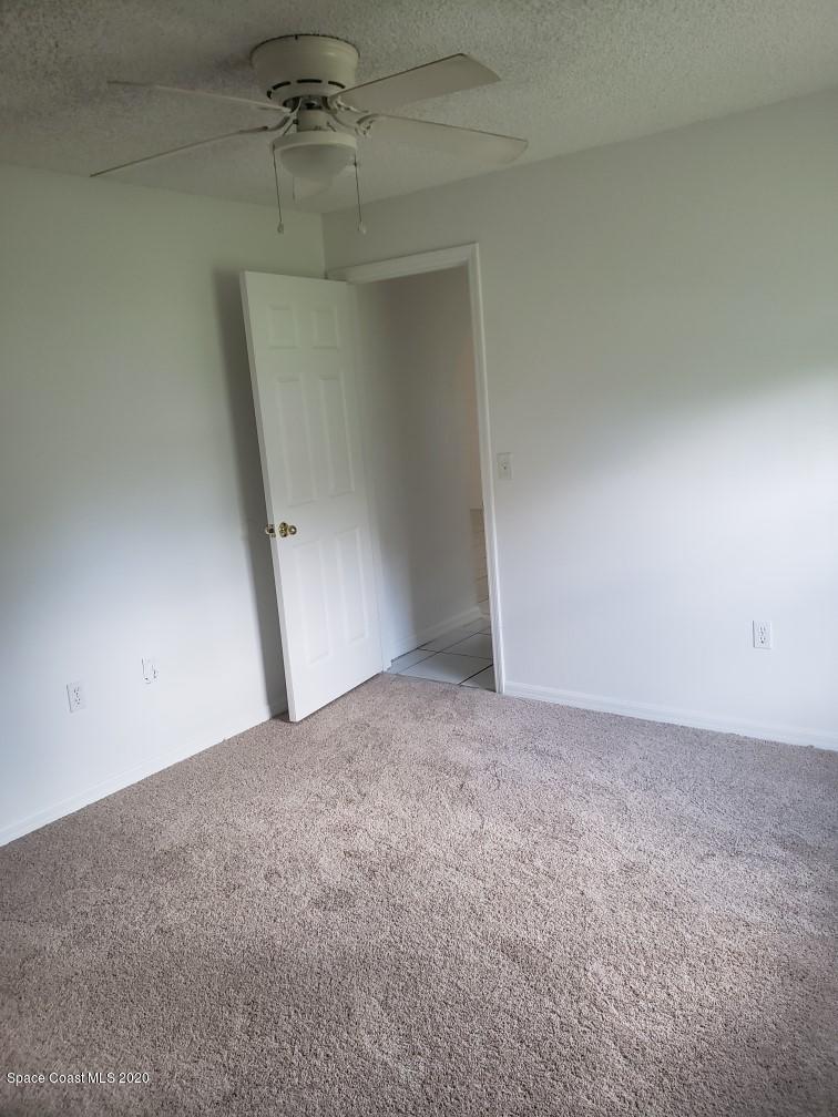 1280 Seabold Road Southwest Palm Bay, FL 32908 - Photo 27 of 28 an empty room with a empty space and a ceiling fan