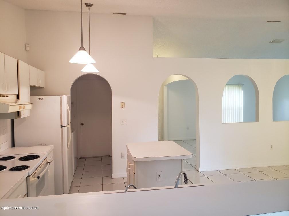 1280 Seabold Road Southwest Palm Bay, FL 32908 - Photo 9 of 28 a view of a kitchen with a sink a refrigerator and cabinets