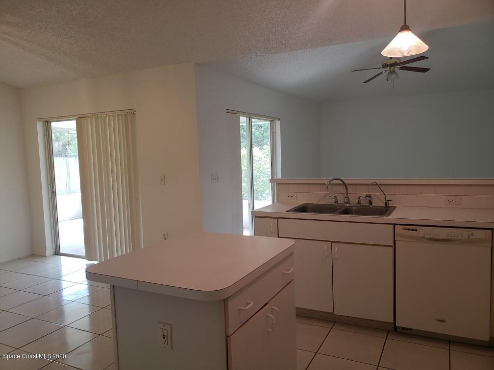 1280 Seabold Road Southwest Palm Bay, FL 32908 - Photo 10 of 28 a kitchen with a sink cabinets and window