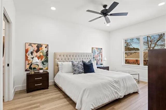 a bedroom with a large bed and a mirror