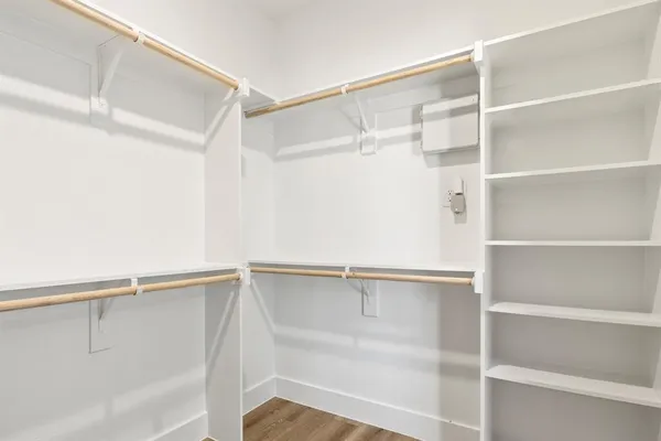 a view of walk in closet with empty racks