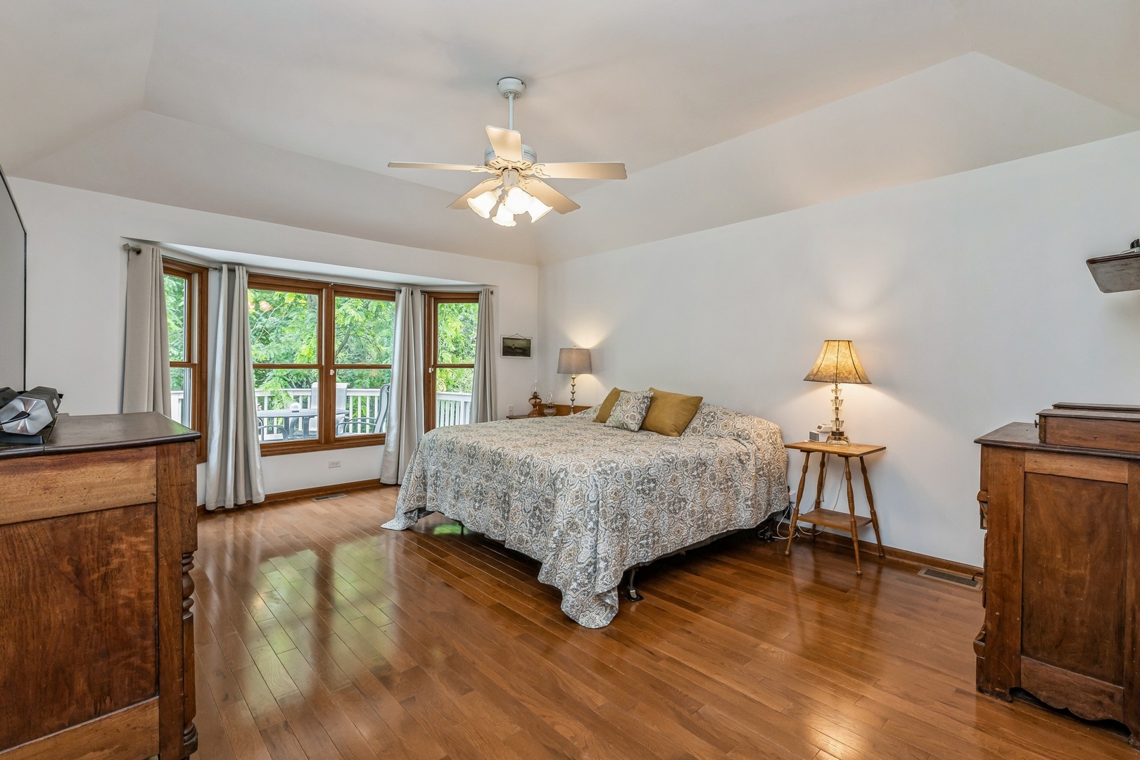 8N681 Edgewood Road Elgin, IL 60124 - Photo 12 of 31 a bedroom with a large bed and a chandelier