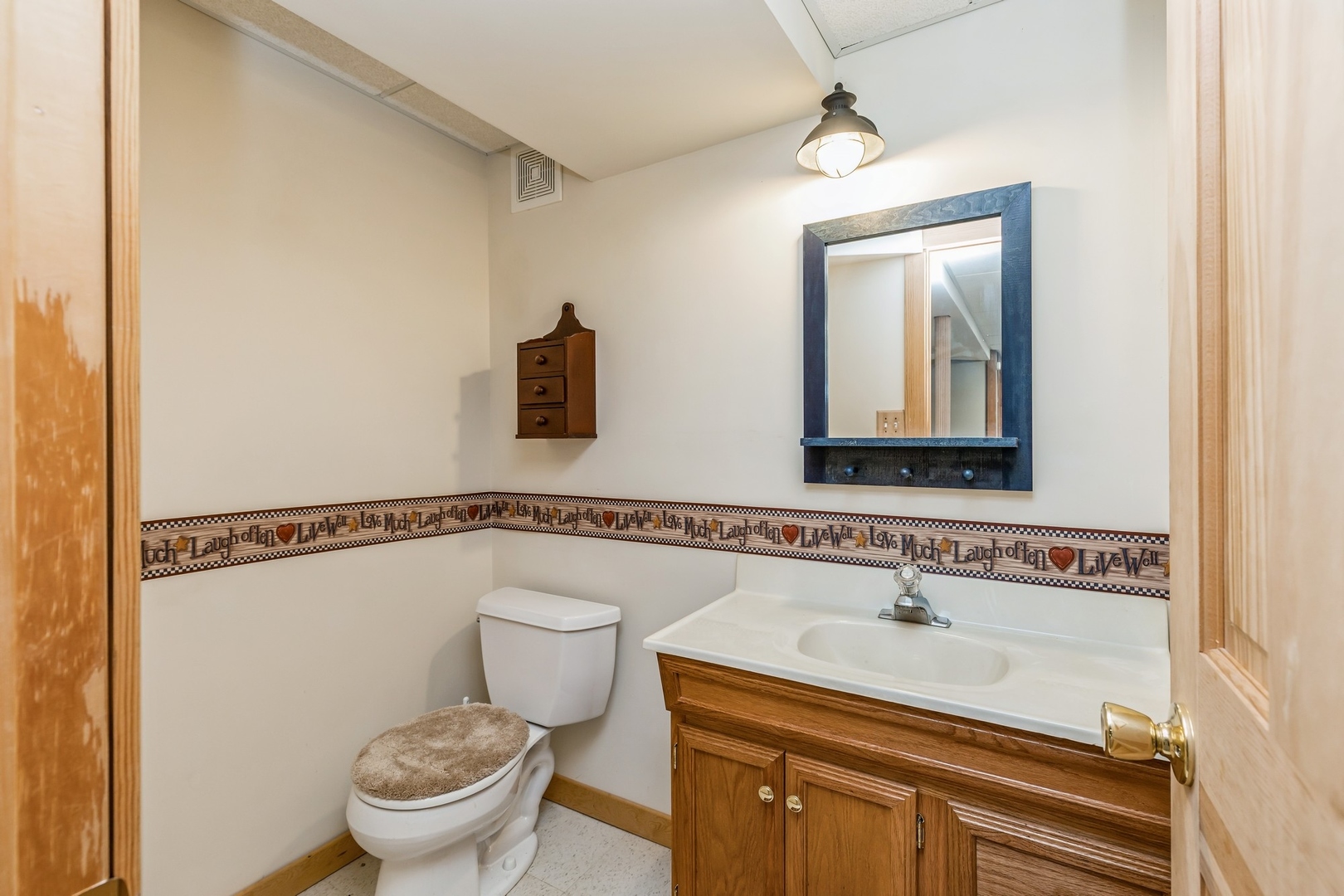 8N681 Edgewood Road Elgin, IL 60124 - Photo 25 of 31 a bathroom with a toilet sink and mirror