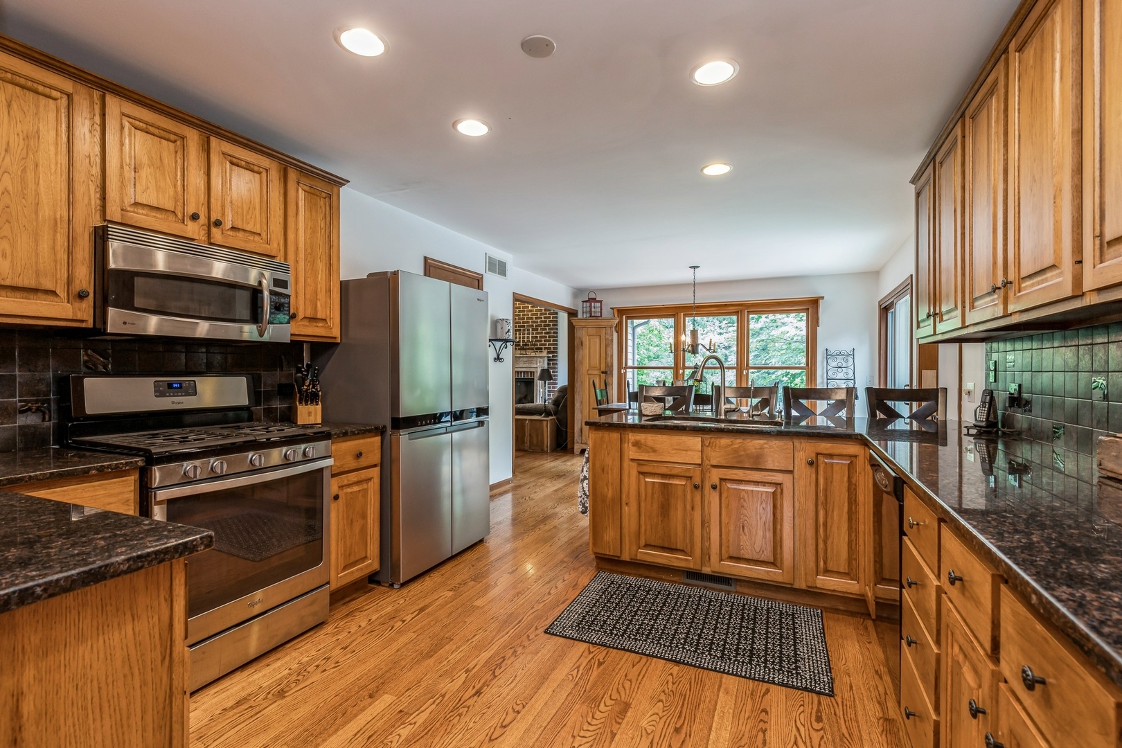 8N681 Edgewood Road Elgin, IL 60124 - Photo 6 of 31 a kitchen with stainless steel appliances granite countertop a stove a sink and a refrigerator