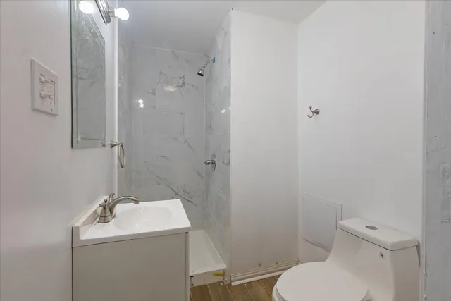a bathroom with a sink toilet and shower