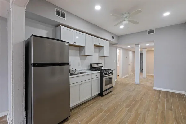 a kitchen with stainless steel appliances a refrigerator and a stove top oven
