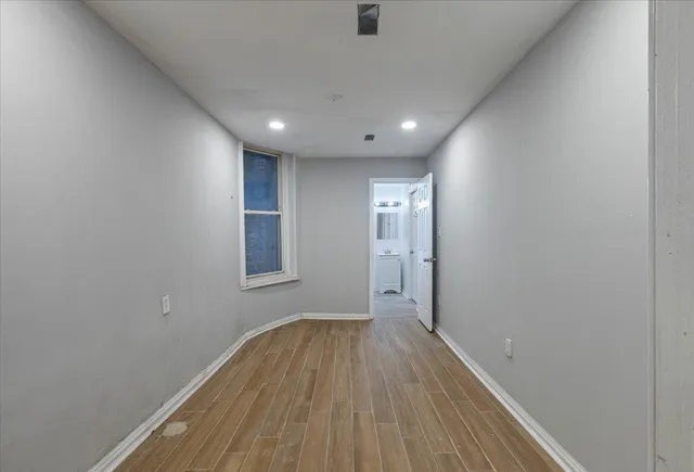 a view of hallway with wooden floor