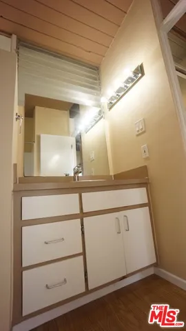 a view of a room with wooden floor and brick walls