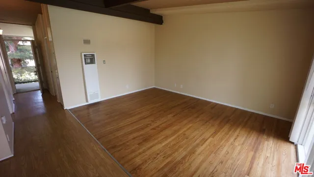 a view of a hallway with wooden floor and a hallway