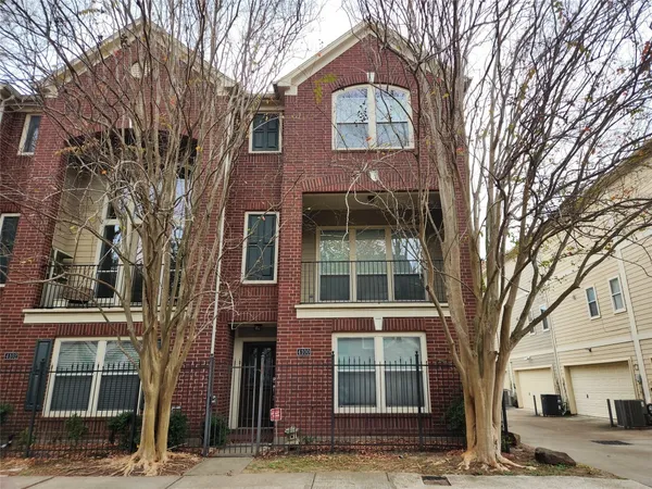 a view of a brick house with a large windows