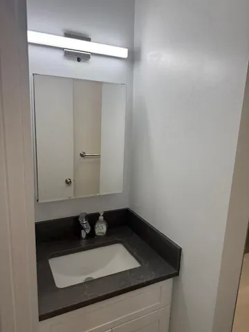 a bathroom with a sink and cabinets