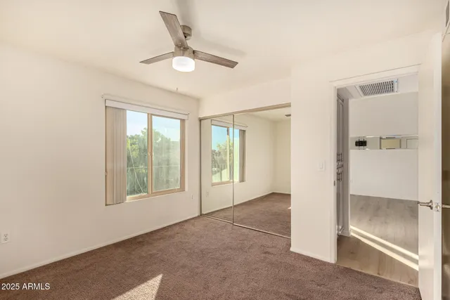 an empty room with windows and closet