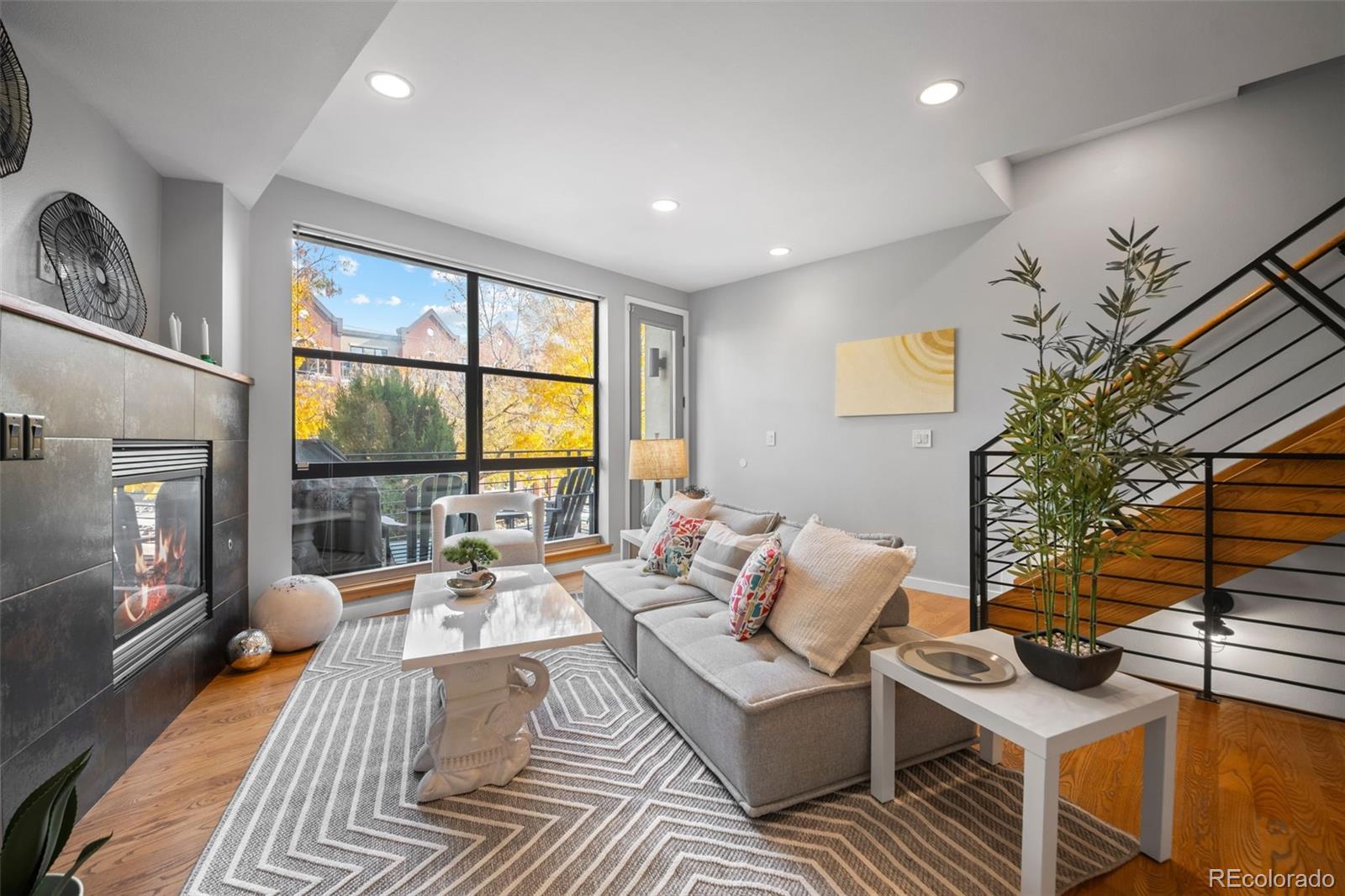a living room with furniture large window and flat screen tv