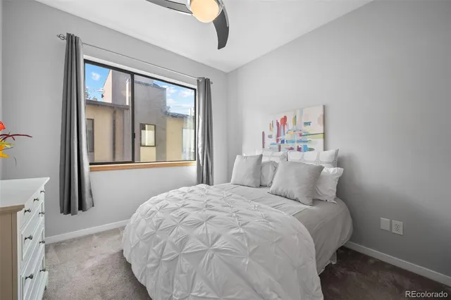 a bedroom with a large bed and a large window