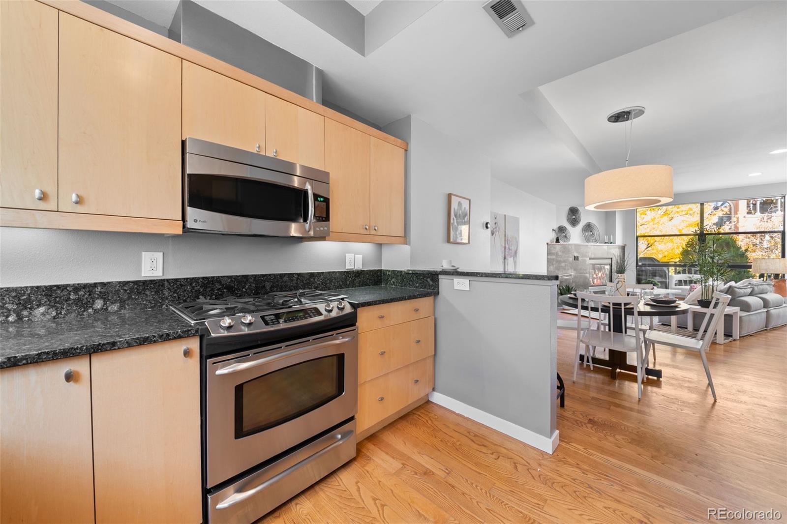 516 24th Street Denver, CO 80205 - Photo 13 of 42 a kitchen with stainless steel appliances a stove a sink and a microwave
