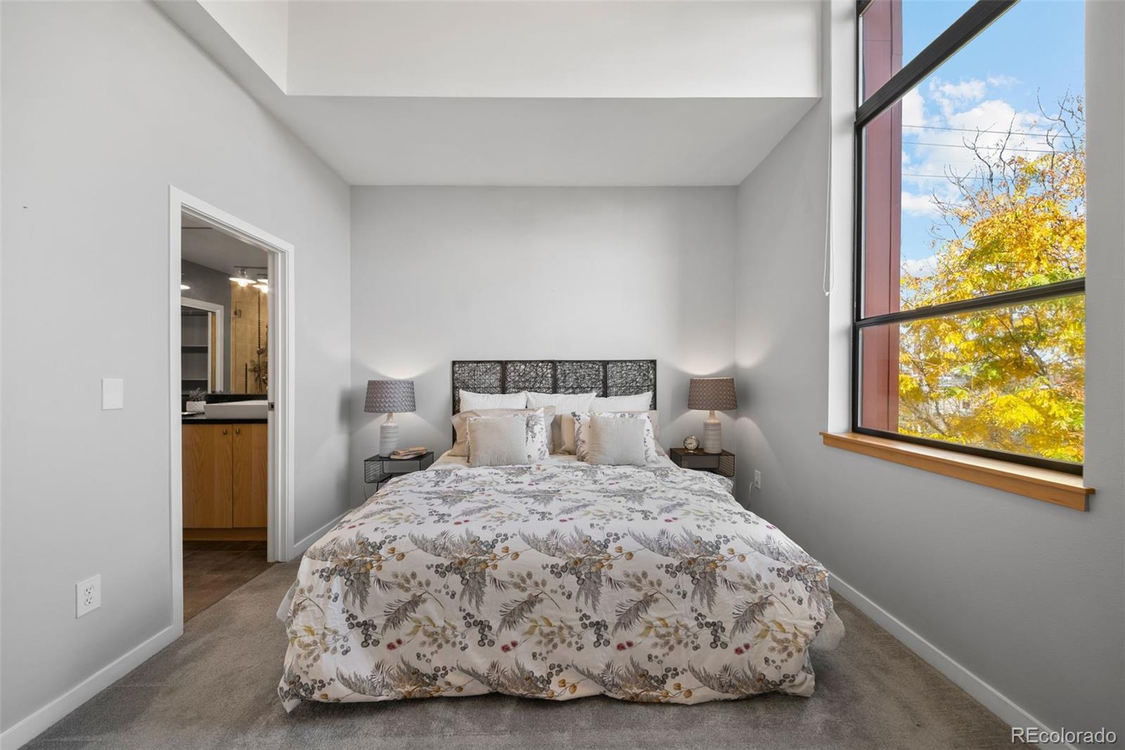 516 24th Street Denver, CO 80205 - Photo 15 of 42 a bedroom with a bed and a painting on the wall